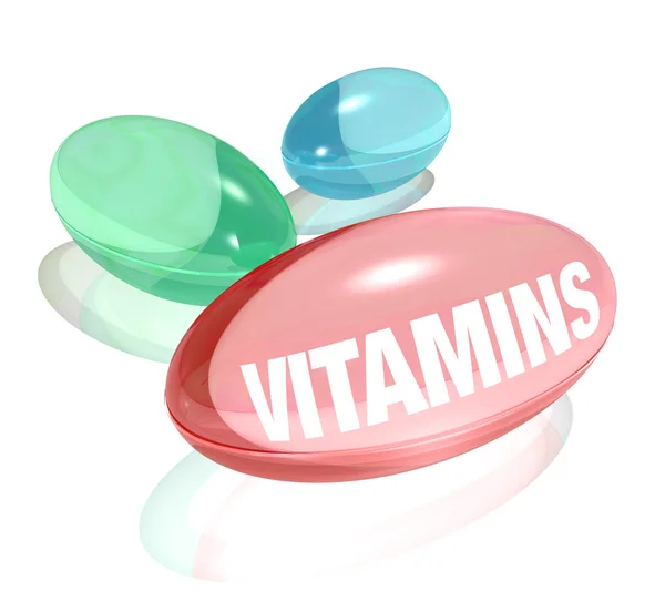 Vitaminas sobre fundo branco e palavra sobre cápsula — Fotografia de Stock