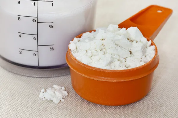 Whey protein isolate powder and almond milk — Stock Photo, Image