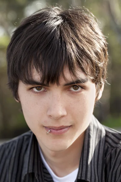 Outdoor portrait teen caucasian boy dark hair — Stock Photo, Image