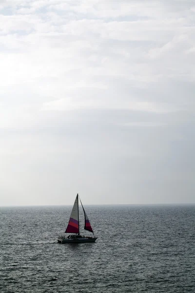 Sailing trimaran on the ocean white clouds — Stock Photo, Image