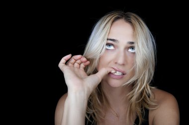 Beautiful blonde woman biting her nails. clipart
