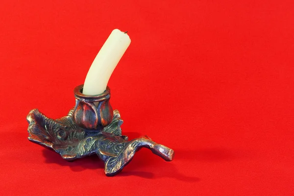 Eine Kerze auf rotem Hintergrund — Stockfoto