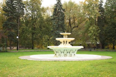 The fountain in the empty city park clipart