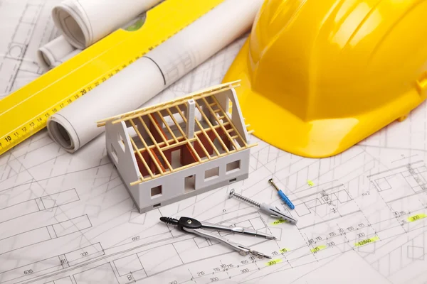 Construction plans with helmet and drawing tools on blueprints — Stock Photo, Image