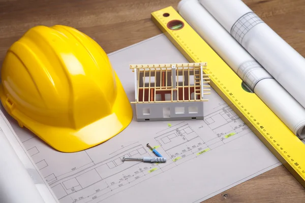 Construction plans and blueprints on wooden table — Stock Photo, Image