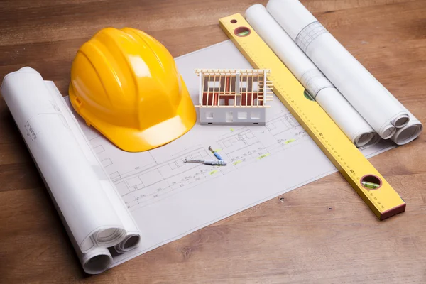 Construction plans and blueprints on wooden table — Stock Photo, Image