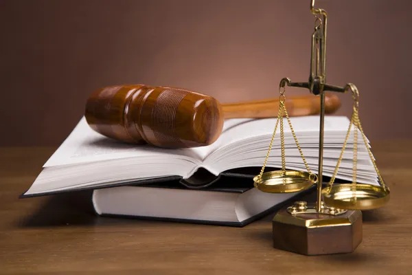 Scales of justice and gavel on desk with dark background — Stok fotoğraf