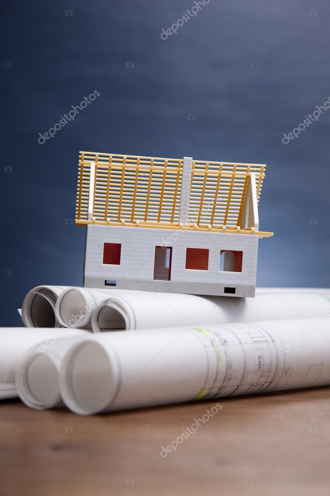 Construction plans and blueprints on wooden table Stock Photo by