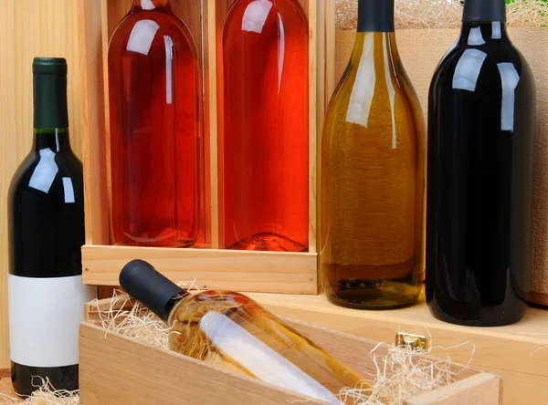 Assortment of wine bottles on crates — Stock Photo, Image