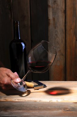 Winemaker's hand with glass clipart