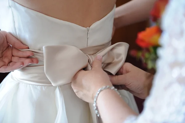 Mutter richtet Brautkleid zurück — Stockfoto