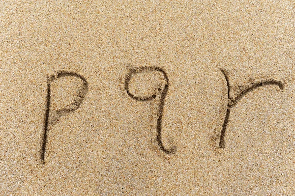 Alphabet letters handwritten in sand on beach — Stock Photo, Image