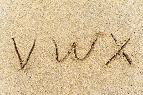 stock image Alphabet letters handwritten in sand on beach