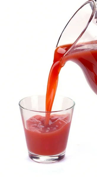 Plum juice is poured from a jug — Stock Photo, Image