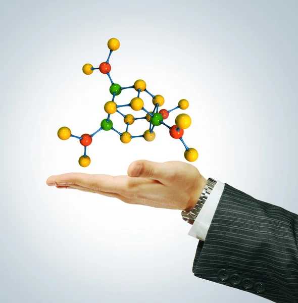 Молекула, выделенная на руку бизнесмену — стоковое фото