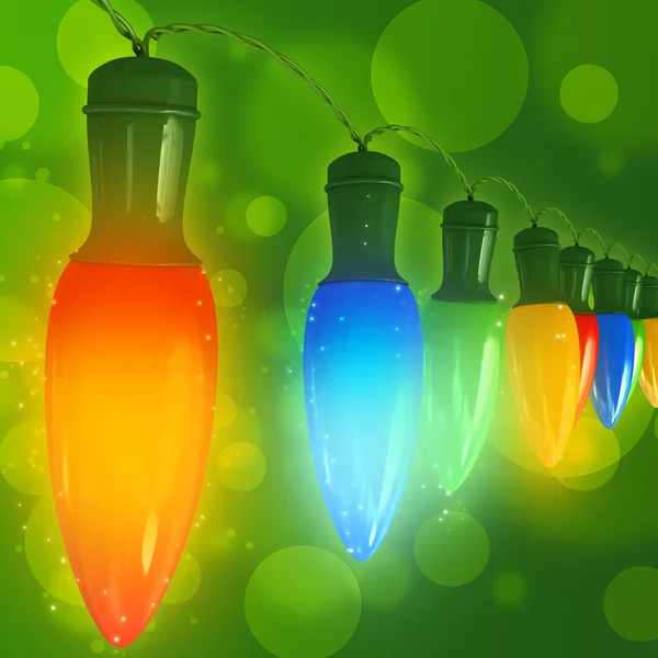 Julbelysning på grön bakgrund — Stockfoto
