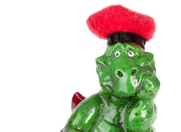 Statuette of funny dragon in red hat — Stock Photo, Image