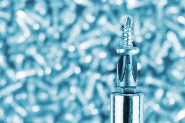 Screwdriver and small screw — Stock Photo, Image