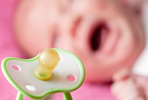 Chupete contra llorando bebé — Foto de Stock