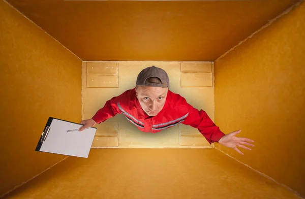 Sad mail courier inside empty box — Stock Photo, Image