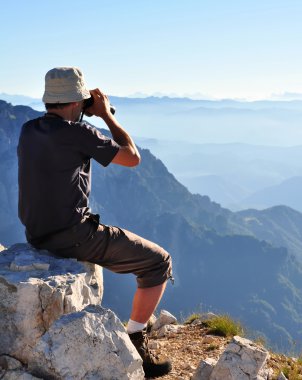 Men with binoculars scanning the horizon clipart
