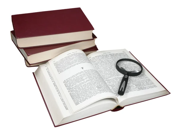 Foot of books and the opened book with a magnifier — Stock Photo, Image