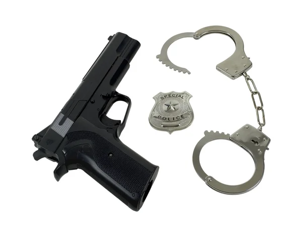 Policejní odznak zbraň a pouta — Stock fotografie