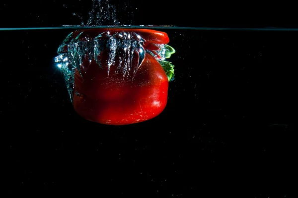 Pepper dropped into water. — Stock Photo, Image