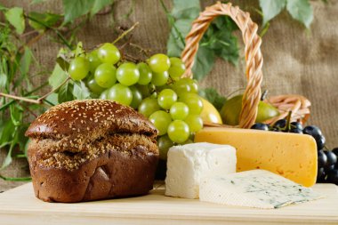 Bread, cheese and grapes still life clipart