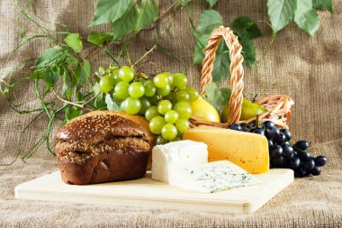 Bread, cheese and grapes still life clipart