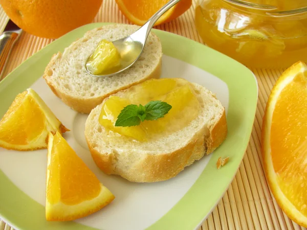 Orange marmalade on baguette — Stock Photo, Image