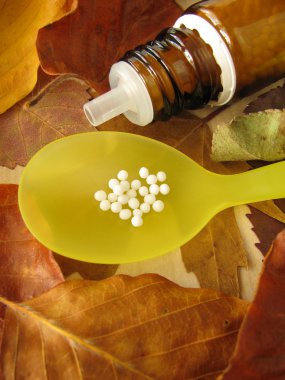 Fall leaves and homeopathic pills clipart