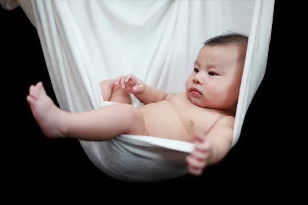 stock image Naked Baby sleeping in White Hammock Sling, isolated on a black background.