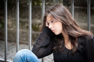 Teenage girl looking thoughtful about troubles clipart