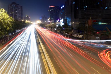 Light trails on rush hour traffic at night clipart