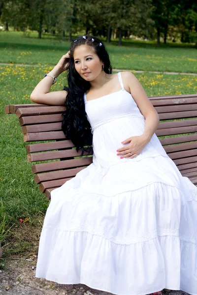 Vackra gravid flicka promenader i parken — Stockfoto