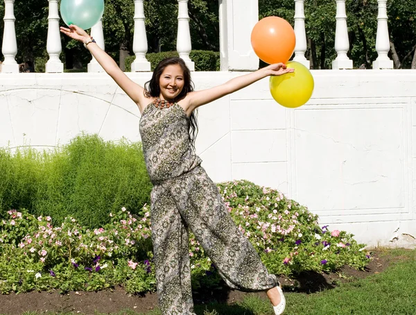 Joyful pregnant girl with colorful balloons — Stock Photo, Image