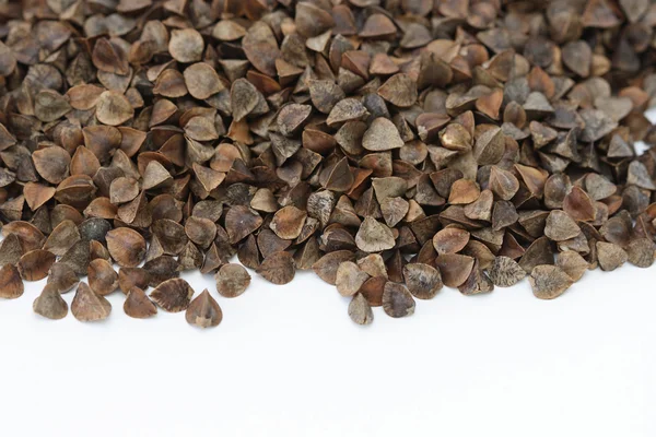 Dry raw buckwheat on white background — Stockfoto