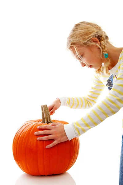 Girl is cutting in big pumpkin — Stock Photo, Image