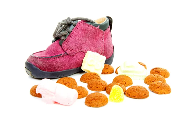 Purple little children's shoe with pepernoten — Stock Photo, Image