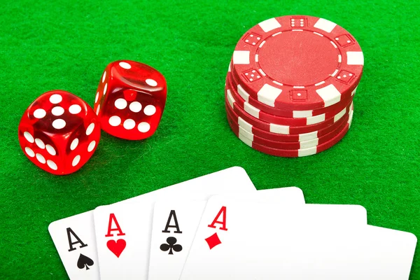 Четыре туза игральные карты и красные кости на зеленом фоне — стоковое фото