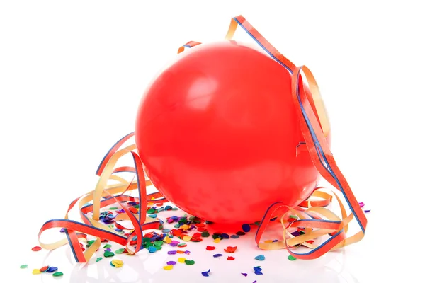 Red party balloon, confetti and streamers — Stock Photo, Image