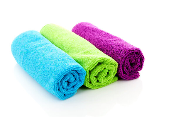 Three colorful rolled towels