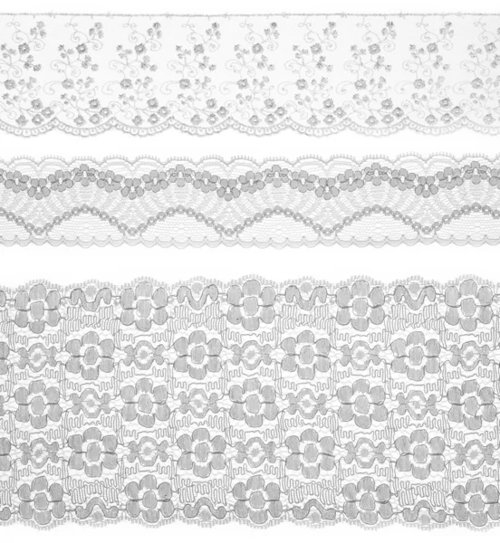 Lace trims ribbon over white. Set of embroidered fabric. Closeup — Stock Photo, Image