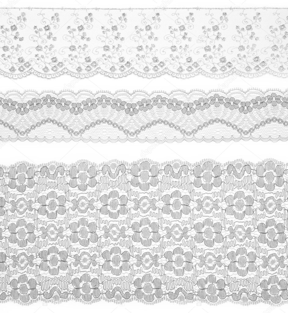 Lace trims ribbon over white. Set of embroidered fabric. Closeup