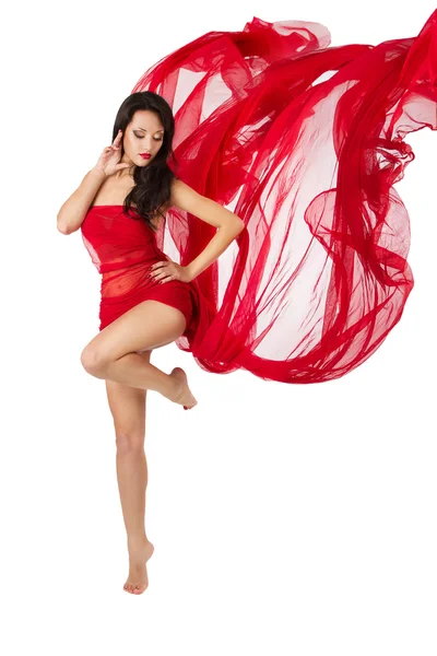 Woman dancing in red flying waving dress on a wind flow. Over w — Stock Photo, Image