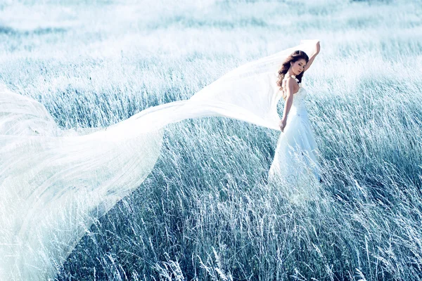 Mariée dans un champ bleu avec tissu ondulé — Photo