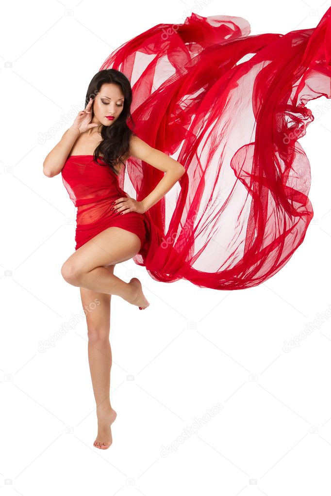 Woman dancing in red flying waving dress on a wind flow. Over w