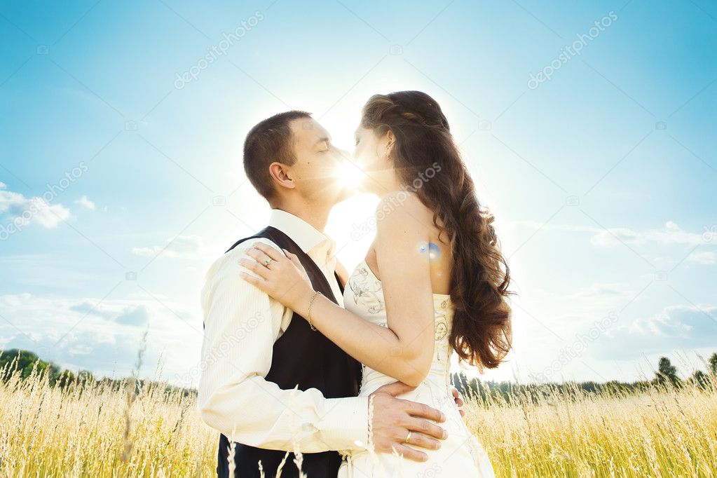 Sunny kiss. bride and groom