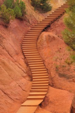 Staircase in a park inside ochre quarry, Roussillion, France clipart